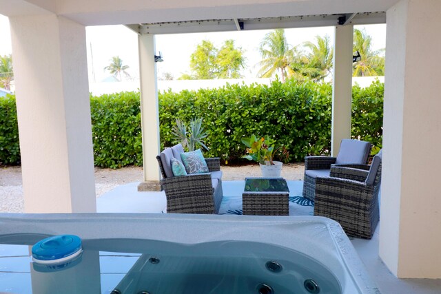 view of patio / terrace featuring outdoor lounge area and a jacuzzi