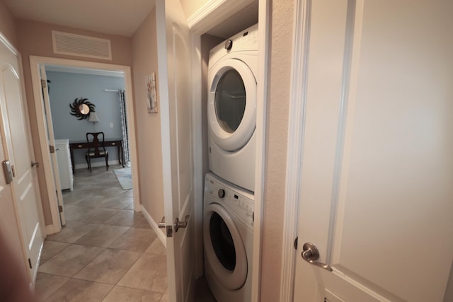 12400 Overseas Hwy Unit 9, Marathon, FL 33050 - laundry room with visible vents, stacked washing maching and dryer, light tile patterned floors, baseboards, and laundry area
