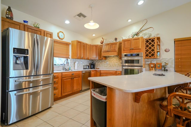 564 Sombrero Beach Rd, Marathon, FL 33050 - kitchen featuring stainless steel appliances, a sink, a peninsula, light countertops, and decorative backsplash