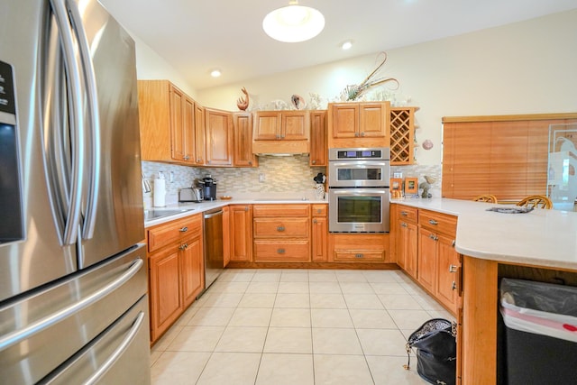 564 Sombrero Beach Rd, Marathon, FL 33050 - kitchen with stainless steel appliances, a peninsula, light countertops, backsplash, and vaulted ceiling