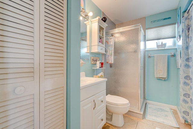 bathroom featuring walk in shower, vanity, toilet, and tile patterned flooring