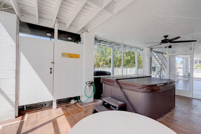 interior space with wood-type flooring, a healthy amount of sunlight, and a jacuzzi