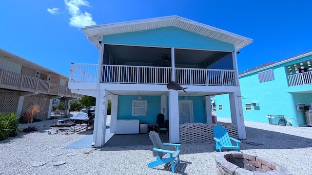 22961 John Avery Ln, Cudjoe, FL 33042 - back of property featuring an outdoor fire pit, a ceiling fan, and a patio area