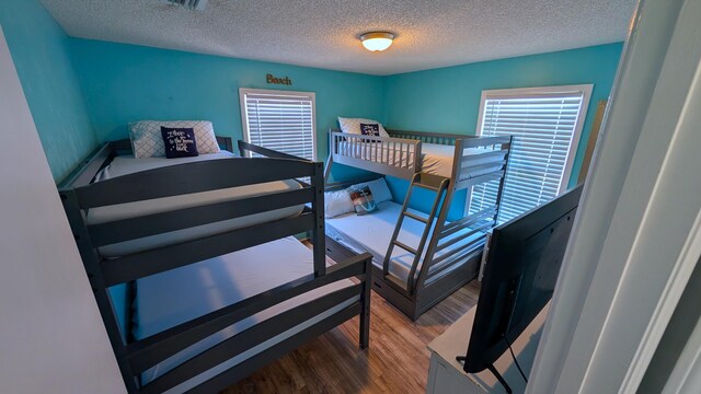 22961 John Avery Ln, Cudjoe, FL 33042 - bedroom featuring wood finished floors and a textured ceiling