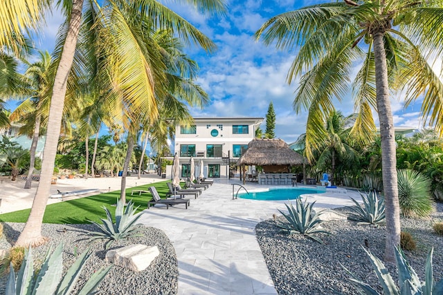 pool with a patio area and a gazebo