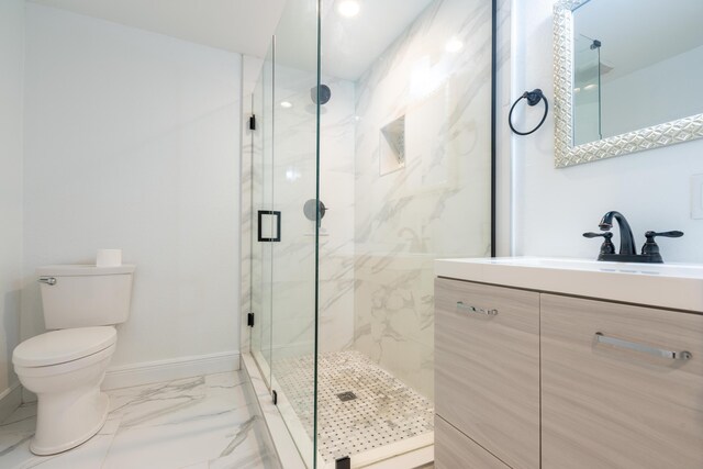 bathroom with vanity, toilet, and a shower with shower door