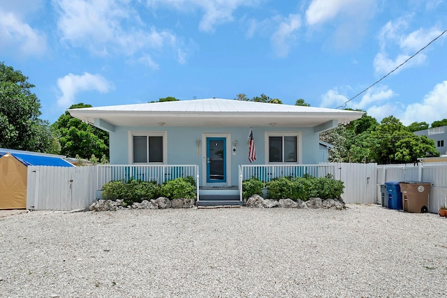939 Plantation Rd, Key Largo, FL 33037 - bungalow-style house with a gate, covered porch, and stucco siding