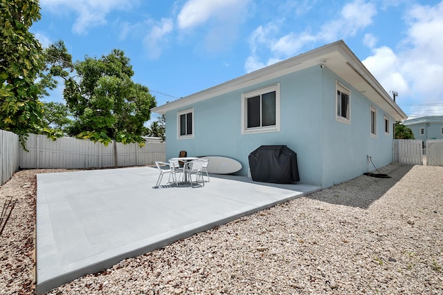 939 Plantation Rd, Key Largo, FL 33037 - rear view of property featuring a fenced backyard, a patio area, and stucco siding