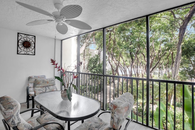 sunroom / solarium featuring ceiling fan