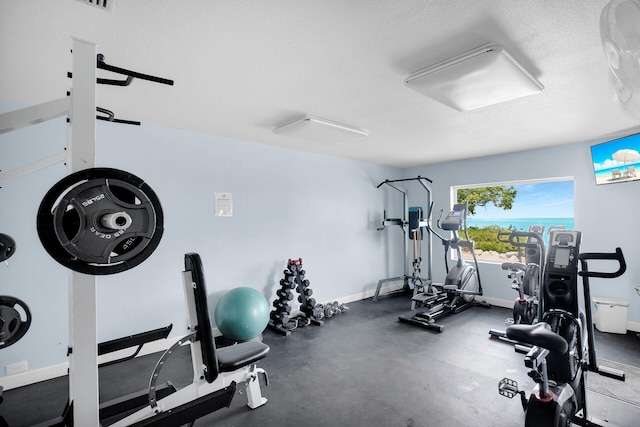 workout room featuring a textured ceiling