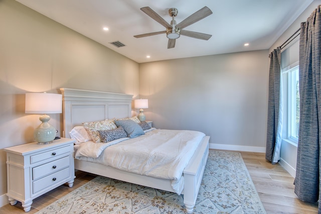 bedroom with ceiling fan and light hardwood / wood-style flooring