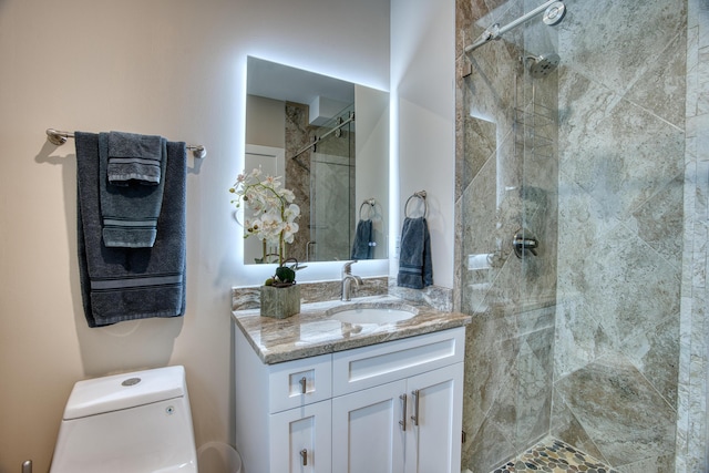 bathroom featuring vanity, toilet, and a shower with door