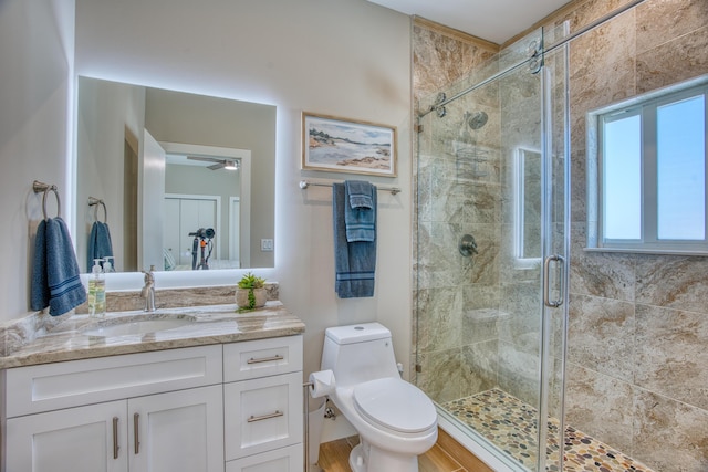 bathroom featuring walk in shower, vanity, and toilet