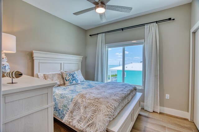 bedroom with ceiling fan, light hardwood / wood-style flooring, and access to outside