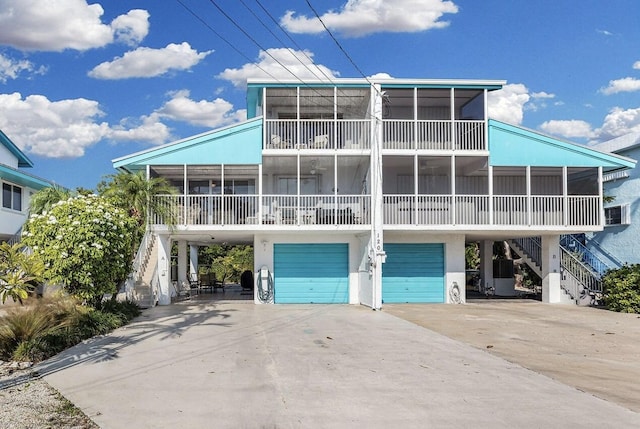 view of front of house with a garage and a sunroom