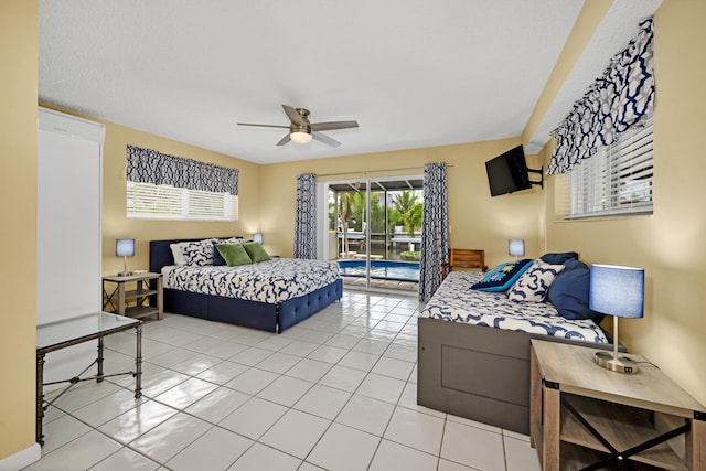 bedroom featuring light tile patterned floors, access to outside, and ceiling fan