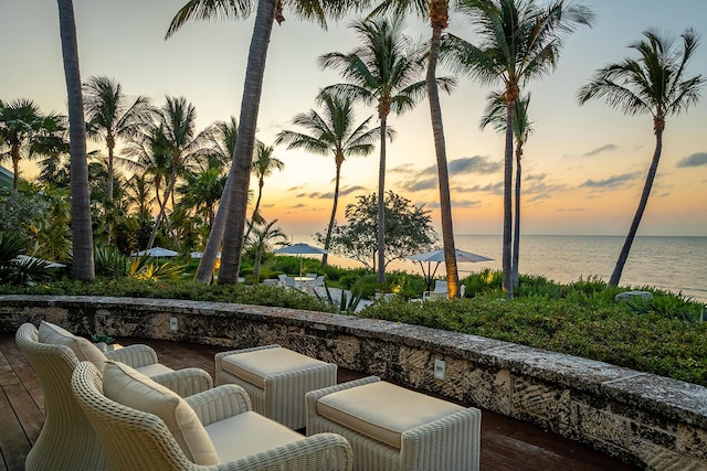 patio terrace at dusk with a deck with water view