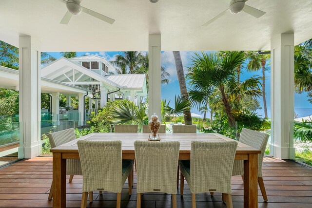 wooden deck featuring a water view and ceiling fan