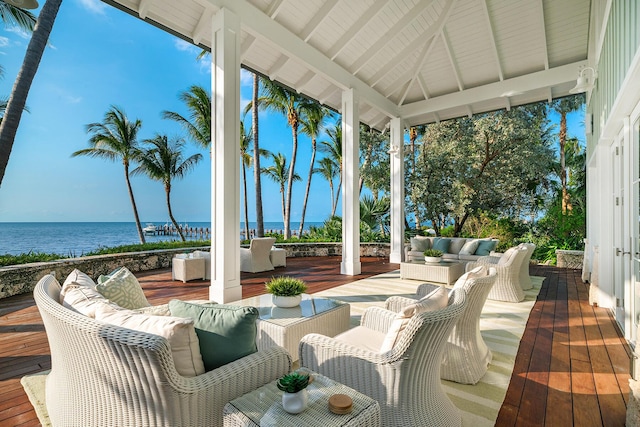 view of patio with a deck with water view, an outdoor living space, and a gazebo