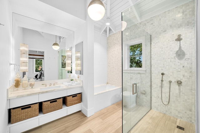 bathroom featuring vanity, wood-type flooring, independent shower and bath, and beamed ceiling