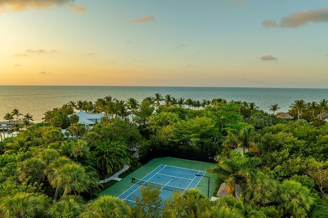 aerial view at dusk featuring a water view