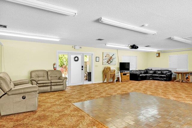 laundry room featuring stacked washer and dryer, light tile patterned floors, cabinets, and beverage cooler