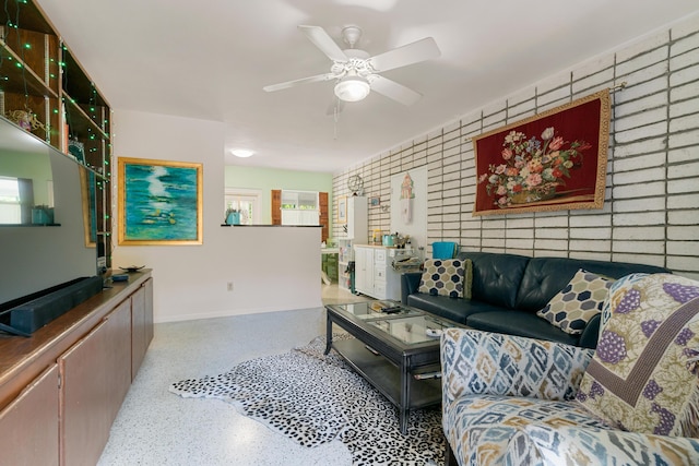 228-230 Apache St, Tavernier, FL 33070 - living room featuring speckle patterned floor, ceiling fan, and an accent wall