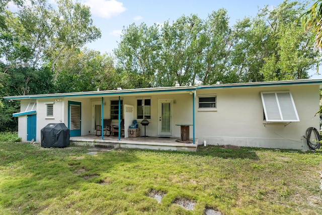228-230 Apache St, Tavernier, FL 33070 - rear view of property with a lawn and a porch