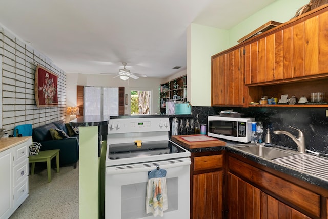 228-230 Apache St, Tavernier, FL 33070 - kitchen with white appliances, backsplash, ceiling fan, brown cabinetry, and dark countertops