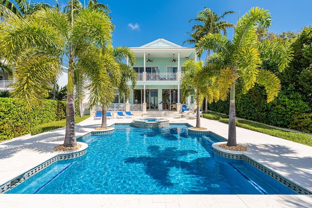 view of pool featuring a patio area, a pool with connected hot tub, and a ceiling fan