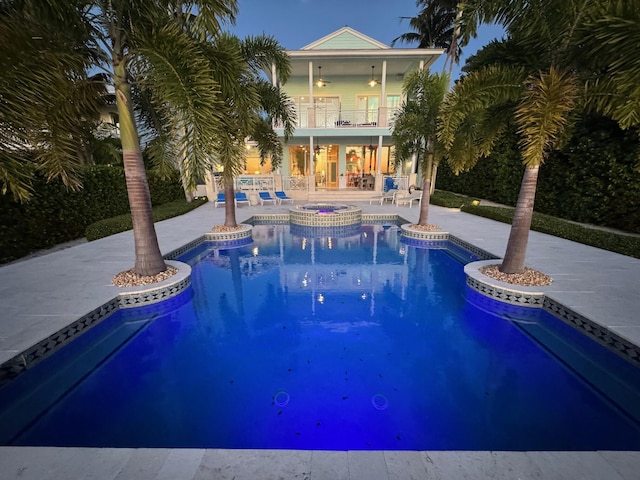 view of swimming pool featuring a patio, a ceiling fan, and a pool with connected hot tub