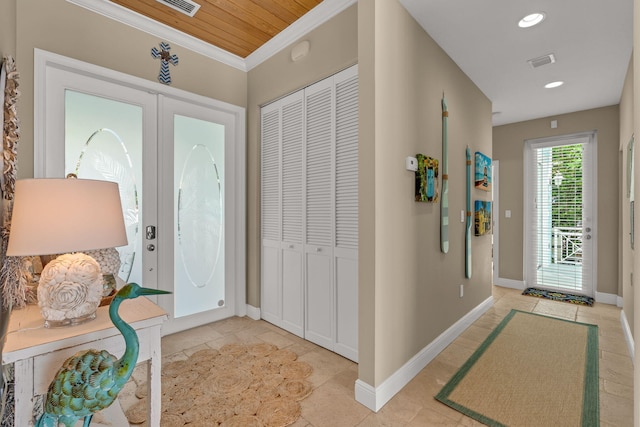 foyer entrance featuring visible vents, ornamental molding, recessed lighting, french doors, and baseboards