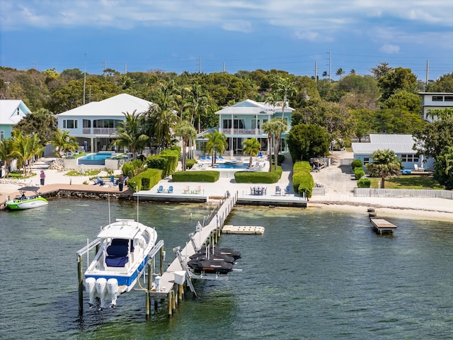 view of dock featuring an outdoor pool, a patio, boat lift, and a water view