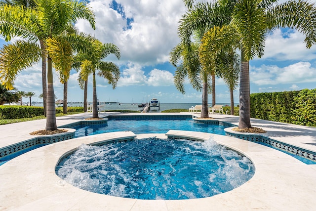 view of swimming pool featuring a pool with connected hot tub