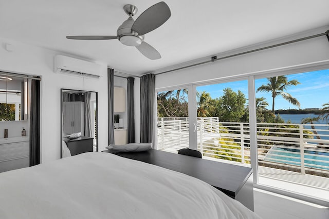 bedroom with an AC wall unit, ceiling fan, and a water view