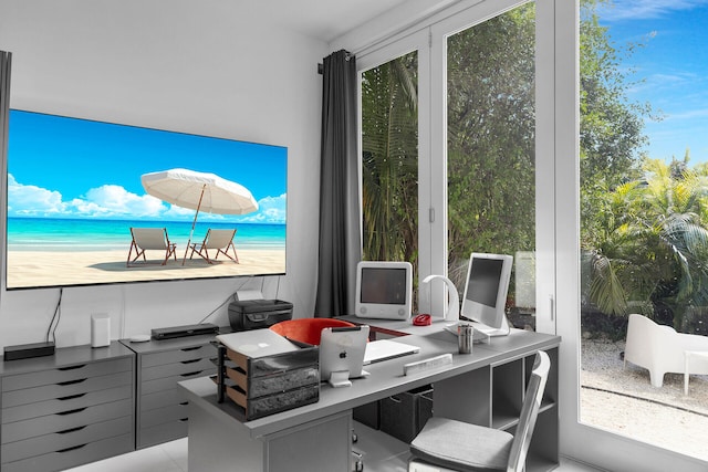 office area with a water view and a view of the beach