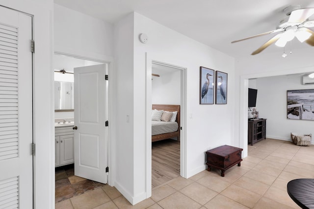 11554 5th Ave, Ocean, Marathon, FL 33050 - corridor featuring baseboards, a sink, light tile patterned floors, and a wall mounted air conditioner