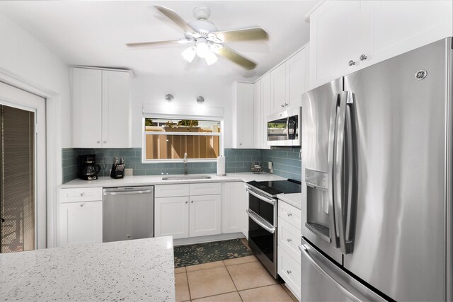 11554 5th Ave, Ocean, Marathon, FL 33050 - kitchen featuring stainless steel appliances, a sink, decorative backsplash, light countertops, and white cabinets