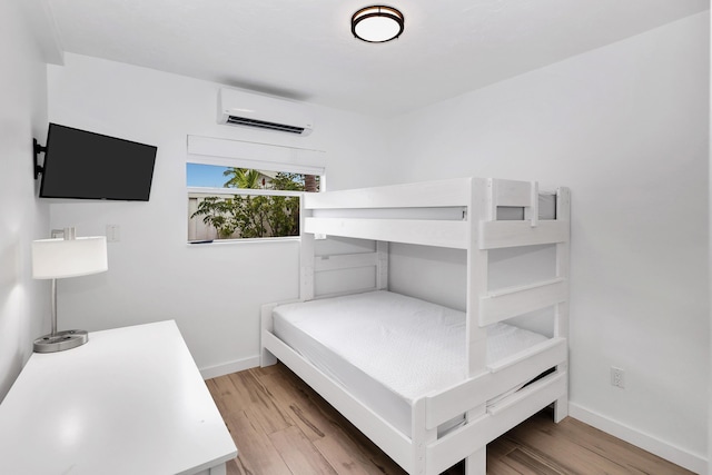 11554 5th Ave, Ocean, Marathon, FL 33050 - bedroom with a wall mounted air conditioner, wood finished floors, and baseboards