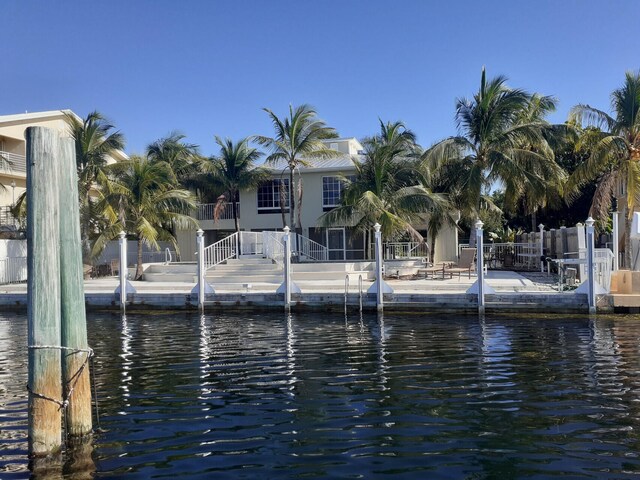 view of dock featuring a water view and a patio