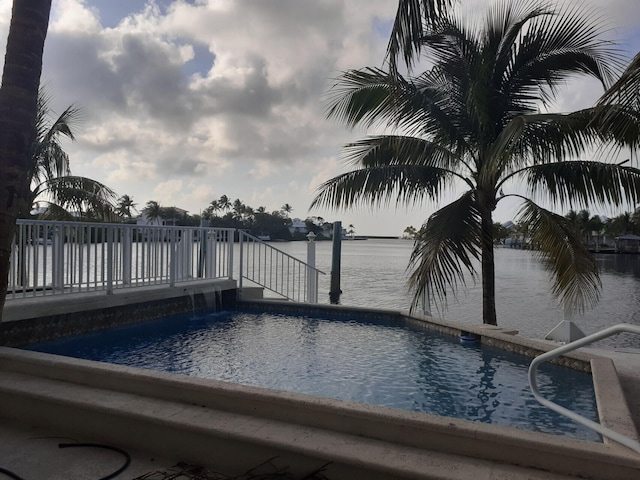 view of pool featuring a water view