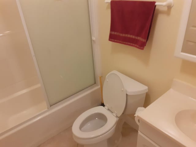 full bathroom featuring vanity, toilet, and combined bath / shower with glass door