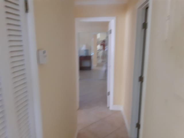 hall featuring light tile patterned flooring