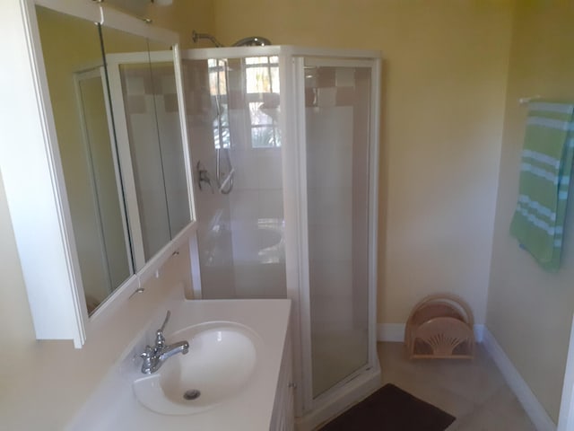 bathroom featuring vanity and a shower with shower door