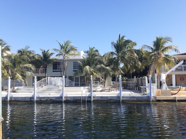 view of dock featuring a water view and a patio