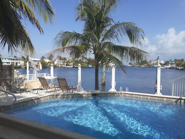 view of swimming pool with a water view