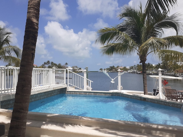 view of pool featuring a water view