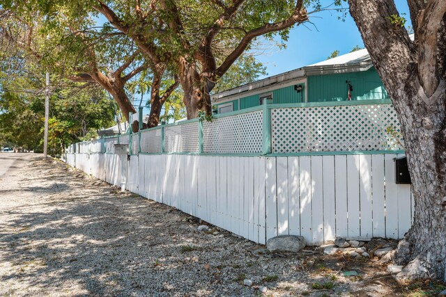 view of side of home featuring fence