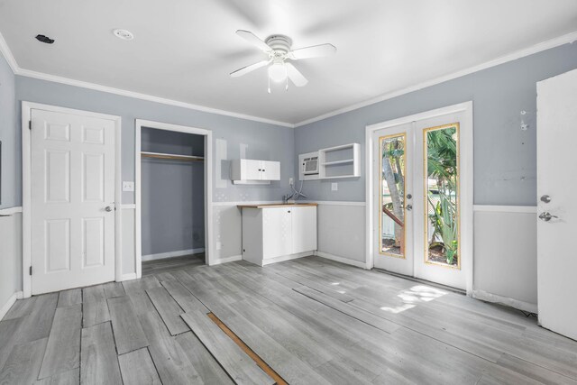 kitchen featuring a sink, appliances with stainless steel finishes, brown cabinetry, and light tile patterned floors