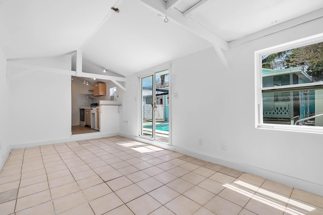 unfurnished room with a wealth of natural light, baseboards, vaulted ceiling with beams, and light tile patterned floors